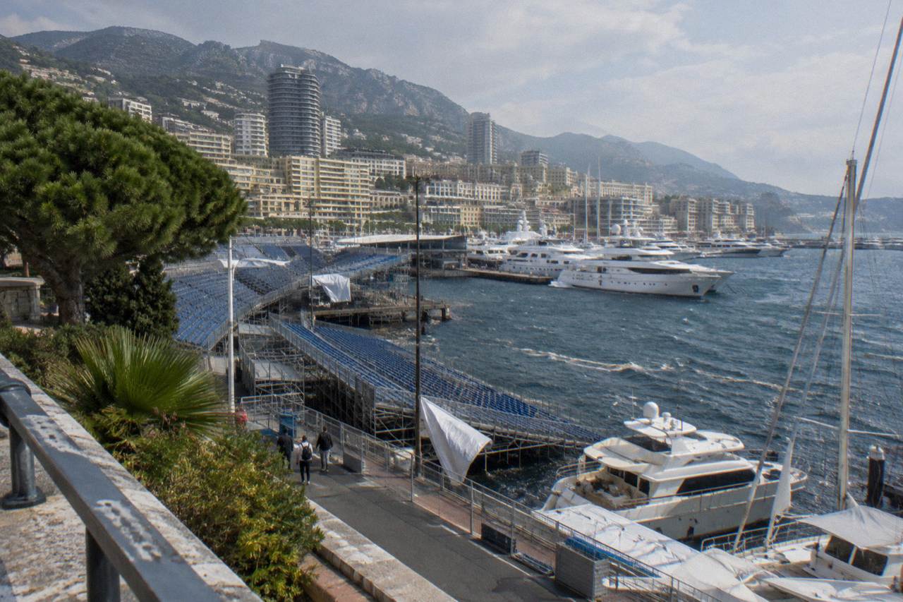 Grand Prix circuit grandstands above Monaco harbour with yachts moored in Port Hercule
