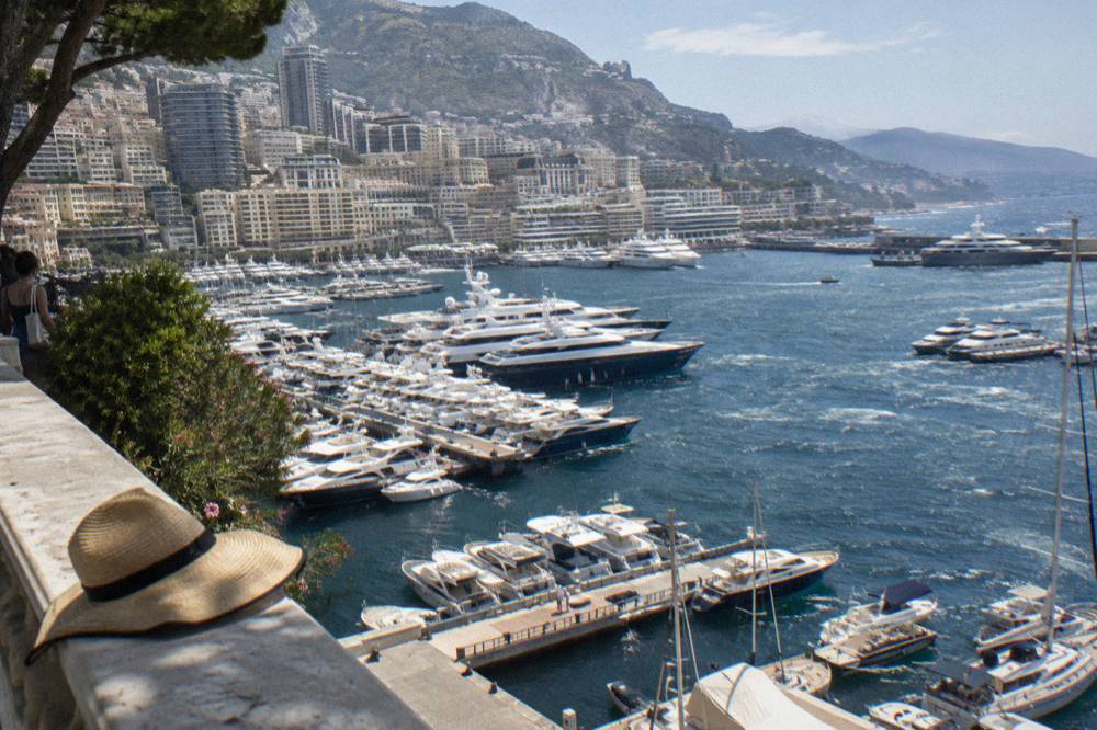 Harbor filled with yachts ringed by buildings under a clear sky