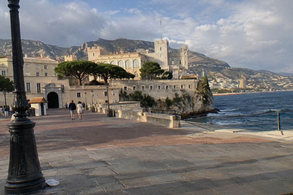 Old town square with palace facade and stone buildings in afternoon light