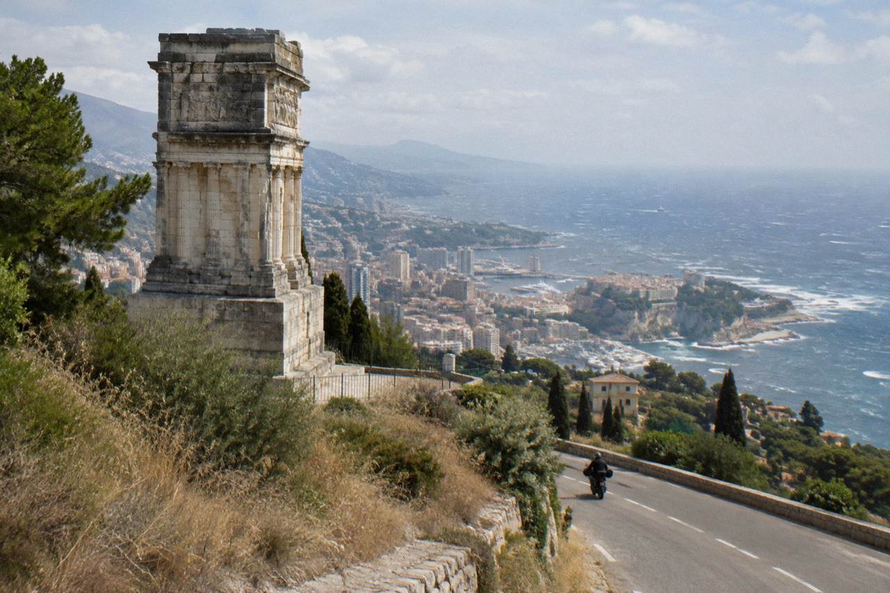 Coastal road curving along the Mediterranean toward Monaco with hills and sea