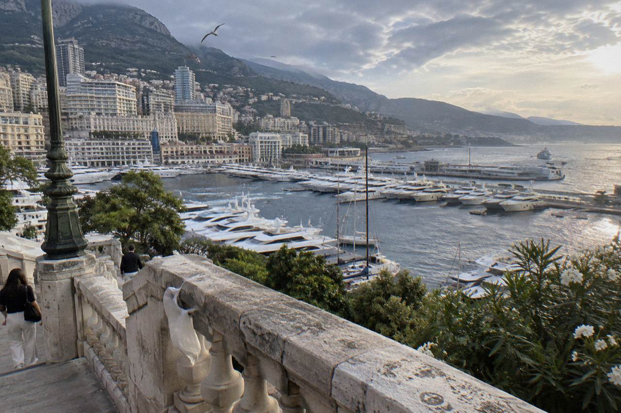 View over Monaco harbor with luxury yachts moored below the hillside buildings