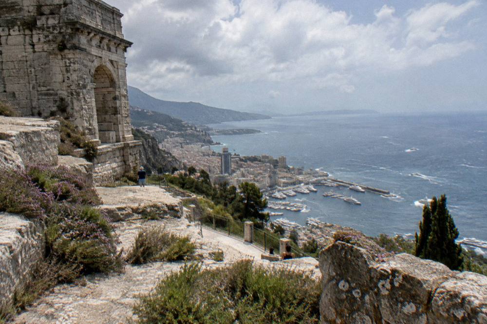 Cliffside road curving above the sea toward a hilltop village