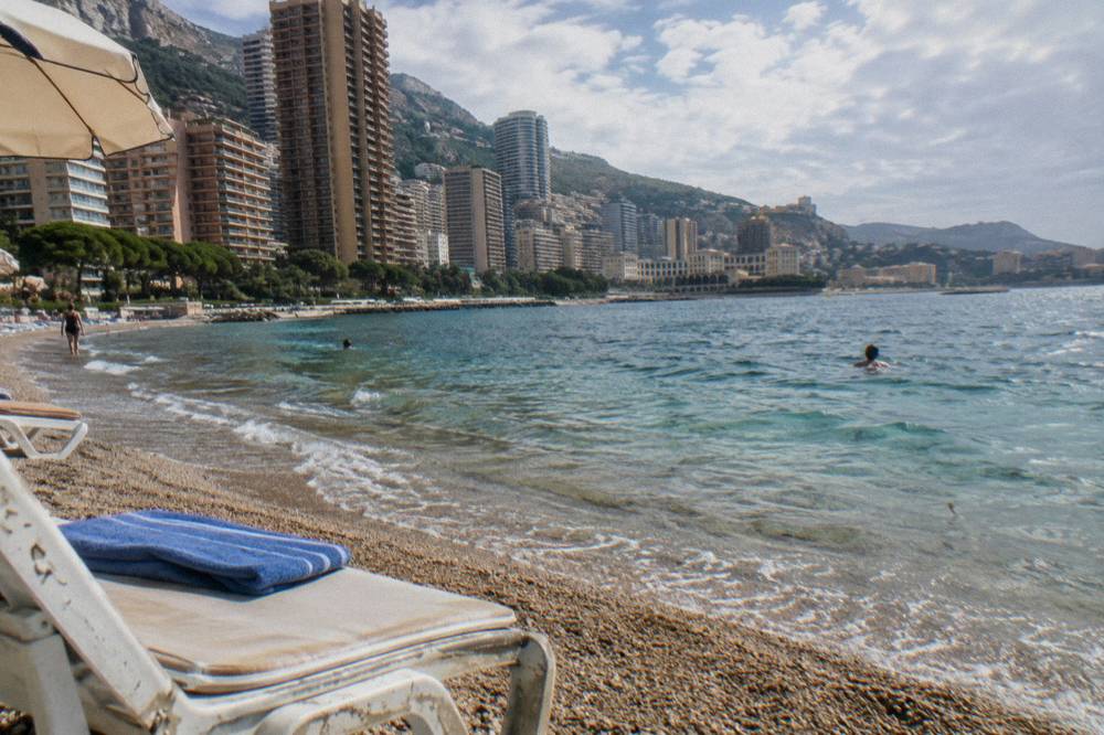 Larvotto beach in Monaco with calm Mediterranean water under a clear sky