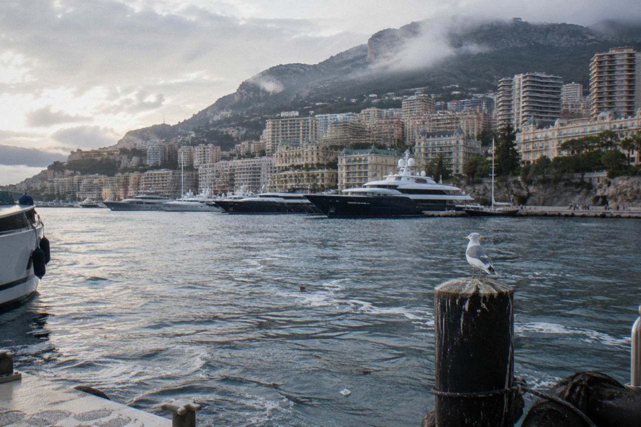 Harbor of Monaco with yachts and hillsides in morning light