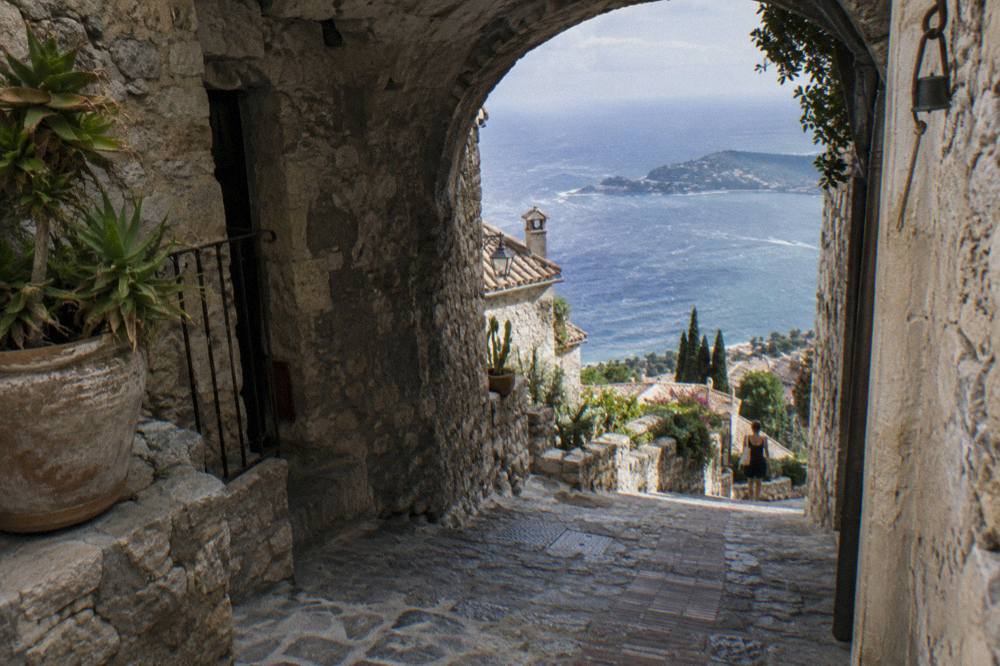 Narrow stone lane in a medieval hilltop village with an arched passage