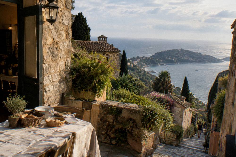 Warm evening light on stone village walls above the sea