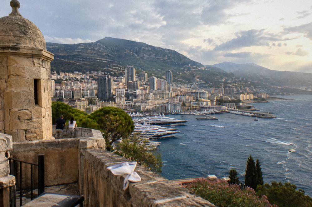 Panorama of Monaco harbor and apartment towers seen from a stone terrace on the Rock