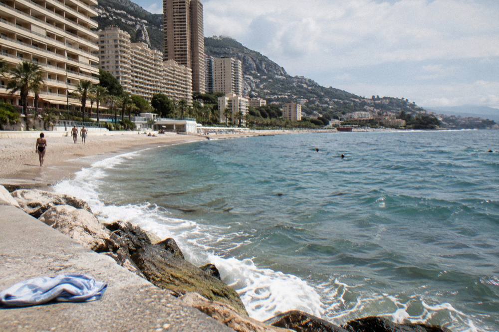 Sunny Mediterranean coastline with cliffs and rooftops