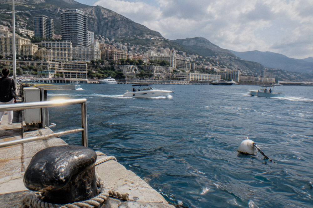 Boats on calm blue water off the Monaco coastline under a clear sky