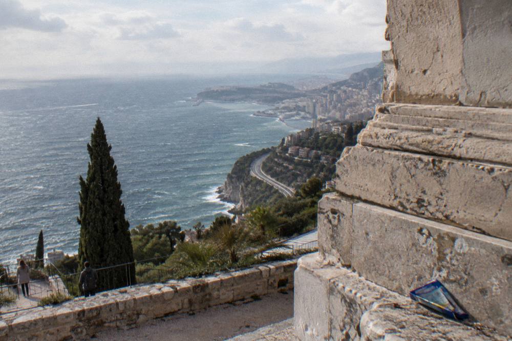 Coastal road with stone pines above the blue Mediterranean between Nice and Monaco