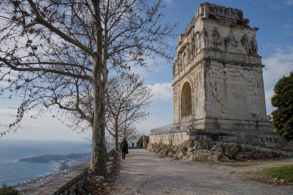 Roman stone monument on a hilltop terrace overlooking the Mediterranean coastline