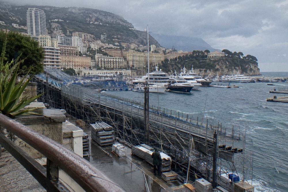 Grandstand scaffolding rising along the Monaco harbor front before race week