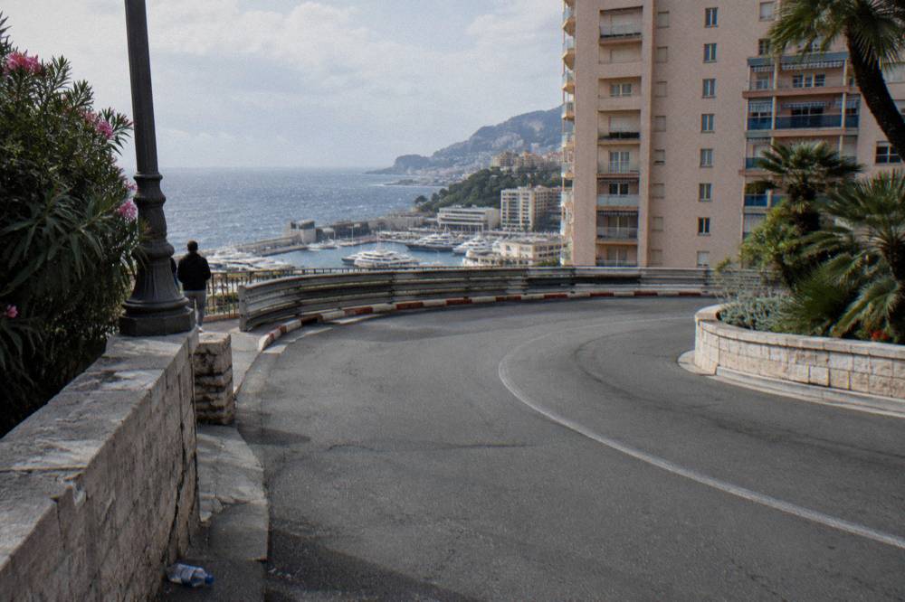 The famous hairpin bend of the Monaco circuit seen from street level with harbor beyond
