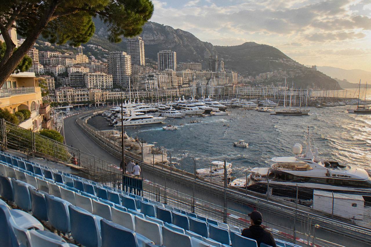 Grandstand seating above the Monaco street circuit with harbor and hills in the background