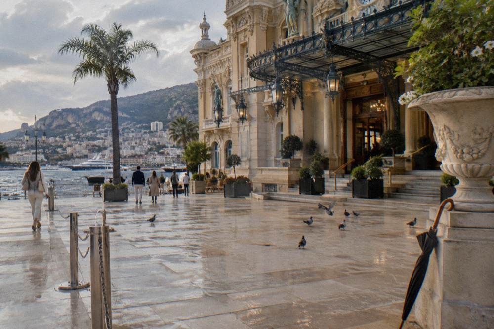 Ornate gilded facade of the Casino de Monte-Carlo seen from the square in late afternoon light