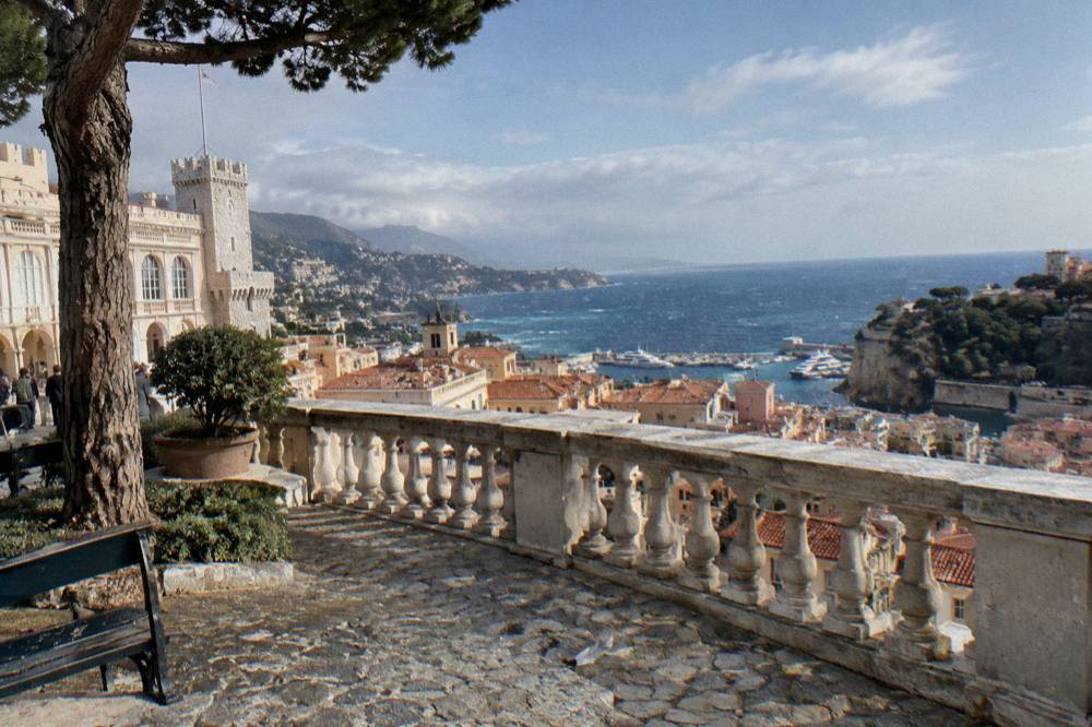 Cars parked on the Palace square above Monaco's red-tiled old town rooftops
