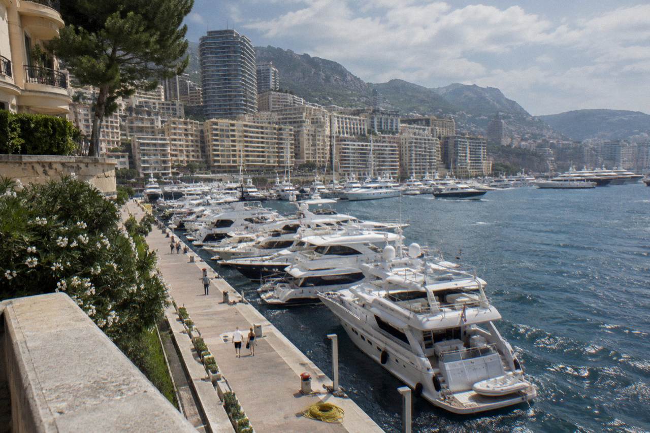 View over Monaco harbor from the Rock with luxury buildings and yachts moored below