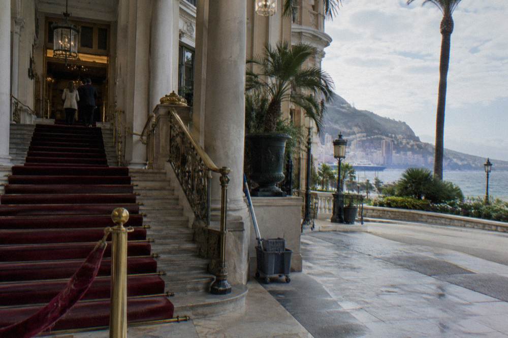 Grand staircase and marble columns inside a Monte Carlo casino entrance hall