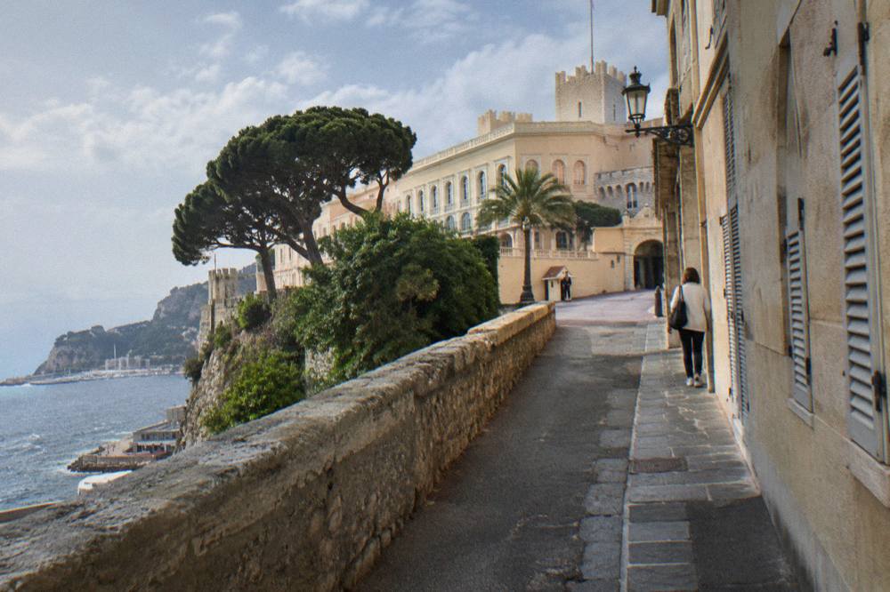 Narrow stone street in Monaco old town with the palace square beyond