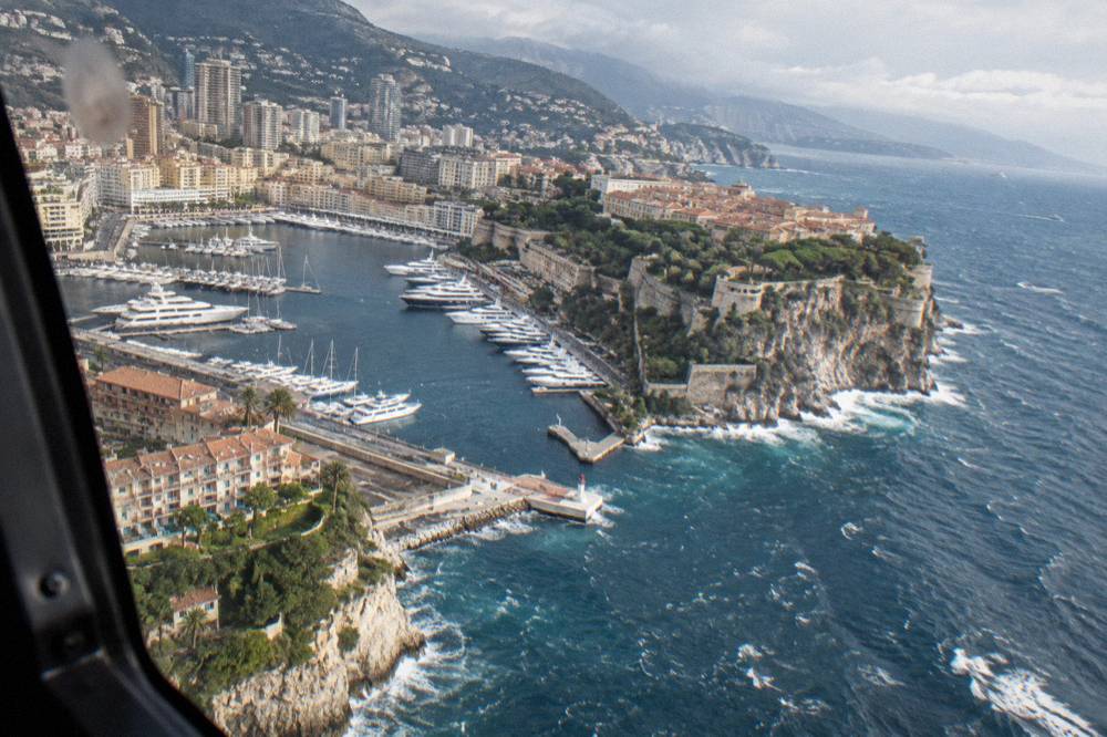 Coastline cliffs and blue sea seen from a helicopter window between Nice and Monaco