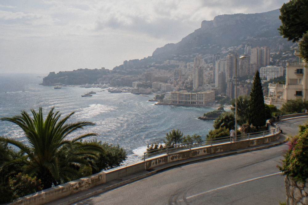 Coastal bus road curving along the waterfront near Cap d'Ail toward Monaco