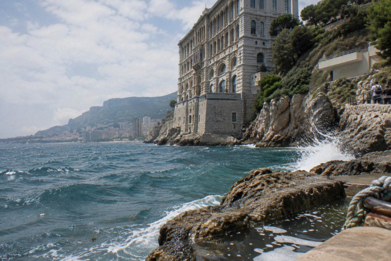 The cliffside facade of the Oceanographic Museum rising above the Mediterranean in Monaco