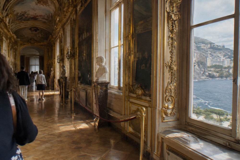 Ornate gilded interior hallway of a palace state apartment with frescoed ceiling