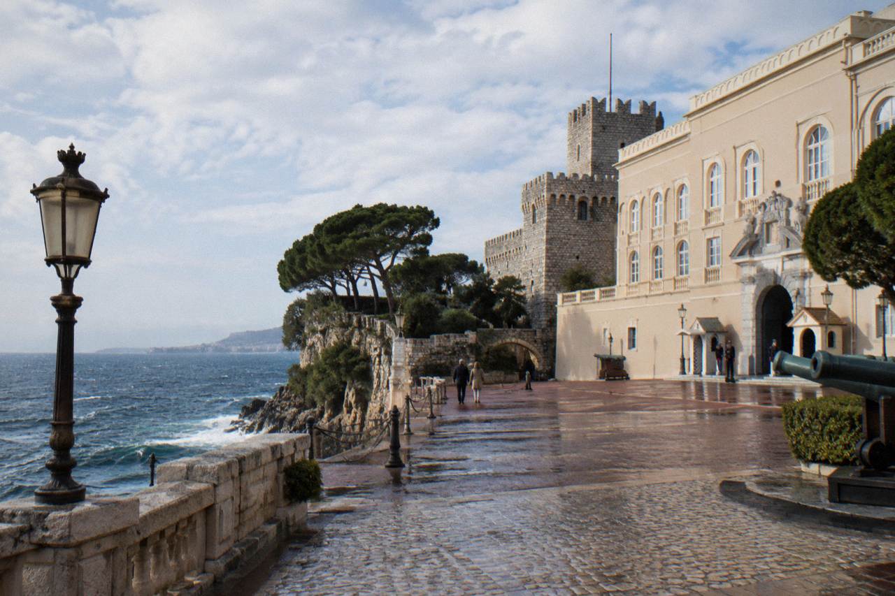 The stone facade and fortified towers of the Prince's Palace on the Rock of Monaco above the Mediterranean