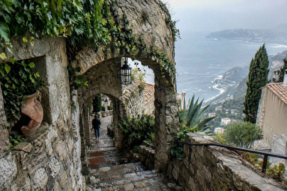 A narrow stone lane in a medieval hilltop village above the Mediterranean