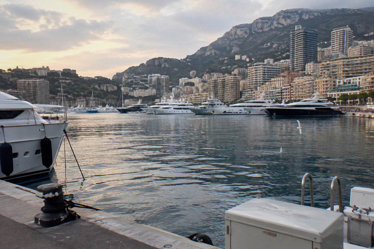 View over Monaco harbor with yachts, hillside buildings and the Mediterranean beyond