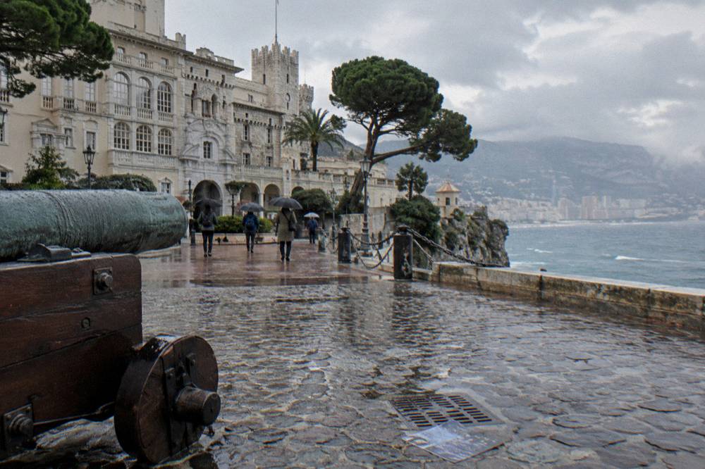 A small guided group walking near the Prince's Palace square on the Rock of Monaco