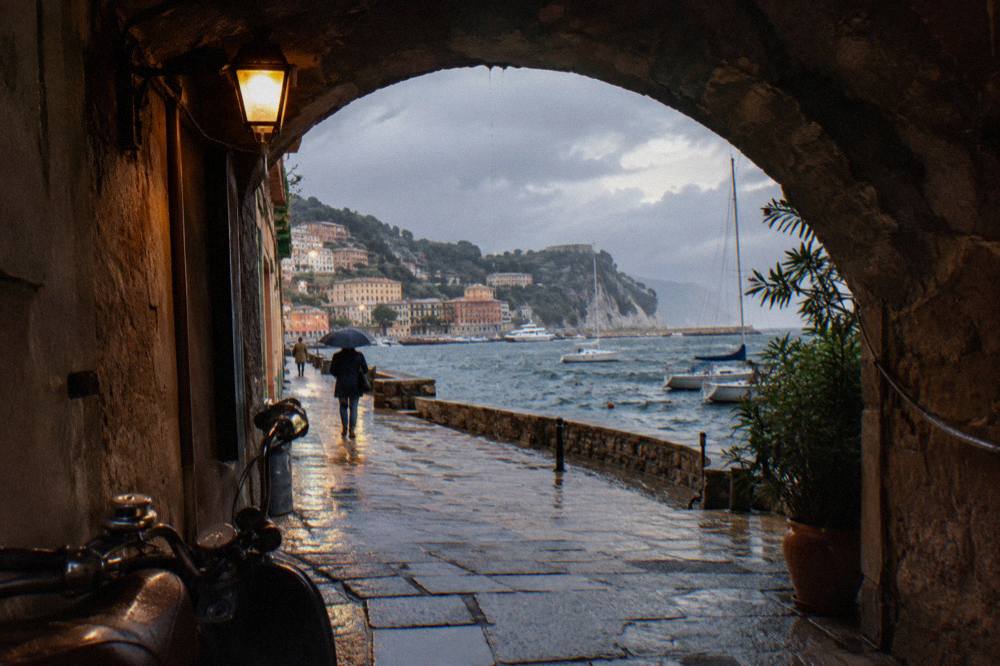 Terracotta and ochre buildings of an old town rising from a Mediterranean bay